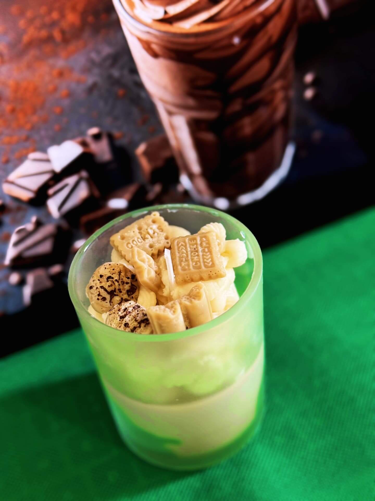 Close-up of a creamy frappe candle topped with sweet decorative elements, ideal for cozy ambiance.