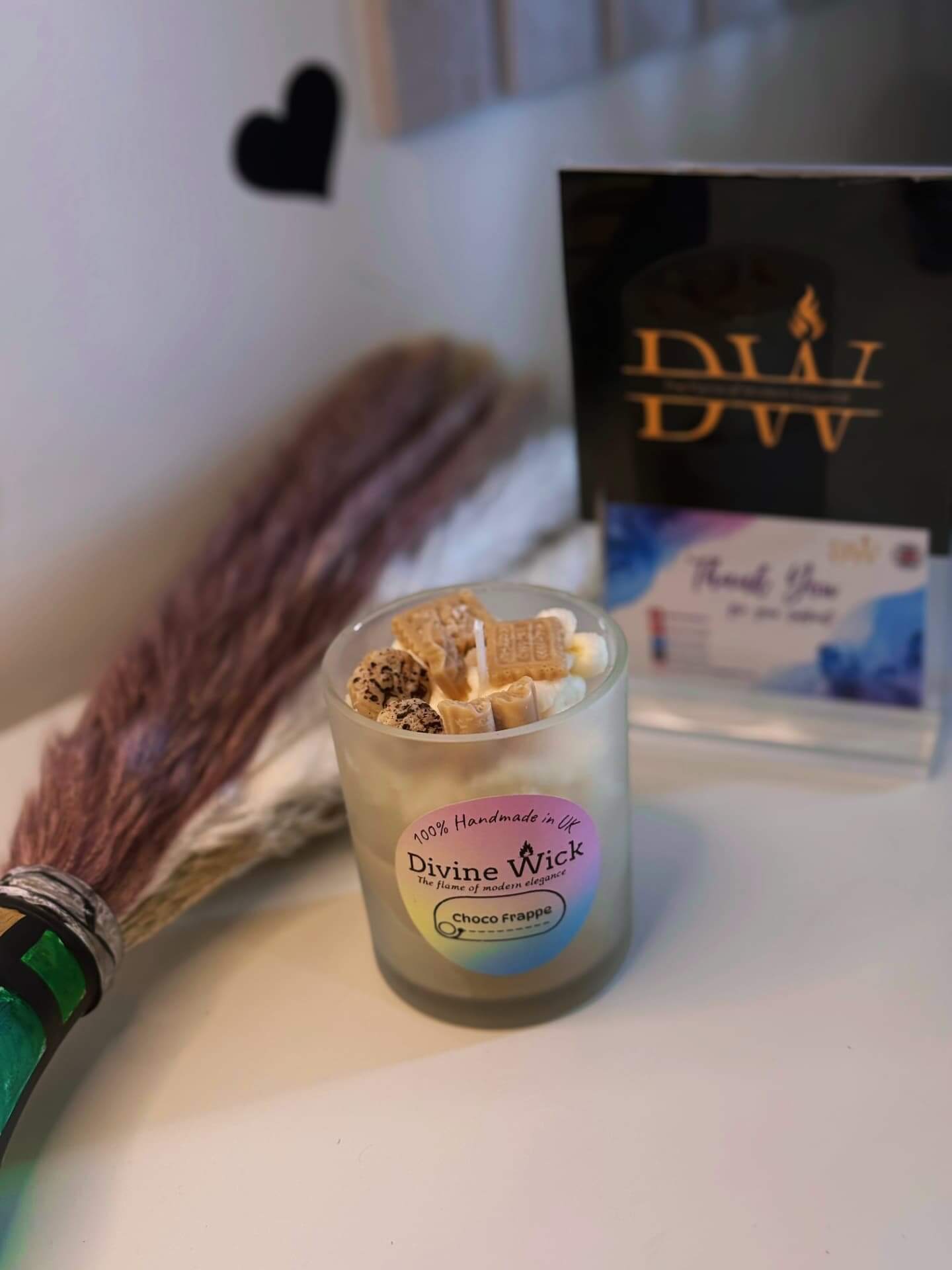 Divine Wick Chocolate Frappe Candle with unique toppings and a thank you card on a cozy table.