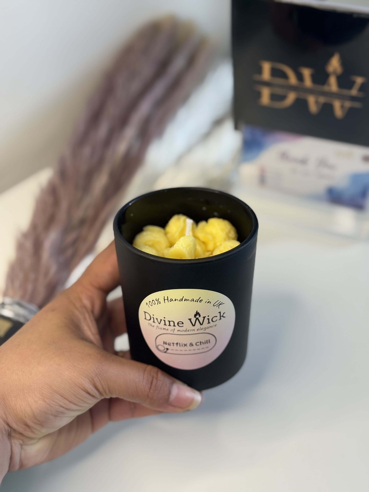Popcorn theme candle in a hand, perfect for movie date nights and relaxing Netflix sessions.